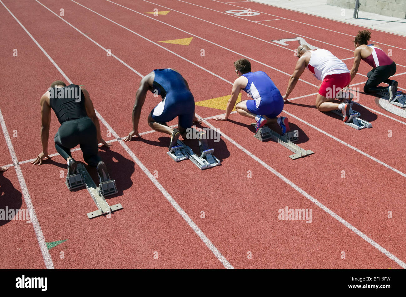 Male sprinters in starting blocks Stock Photo Alamy