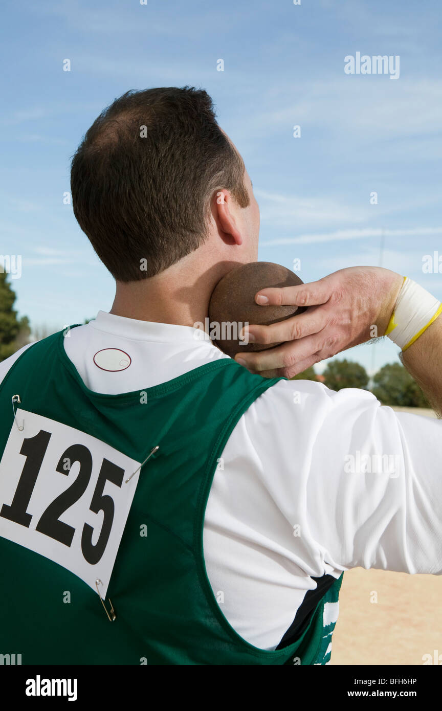 Male shot putter holding shot Stock Photo Alamy