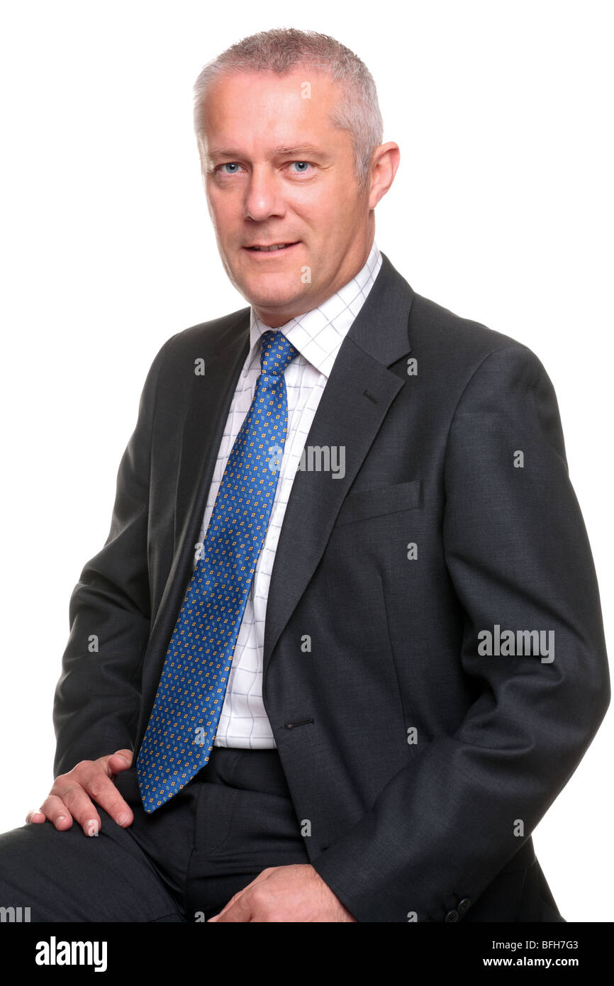 Portrait of a mature businessman wearing a gray suit with blue tie, isolated on a white background. Stock Photo