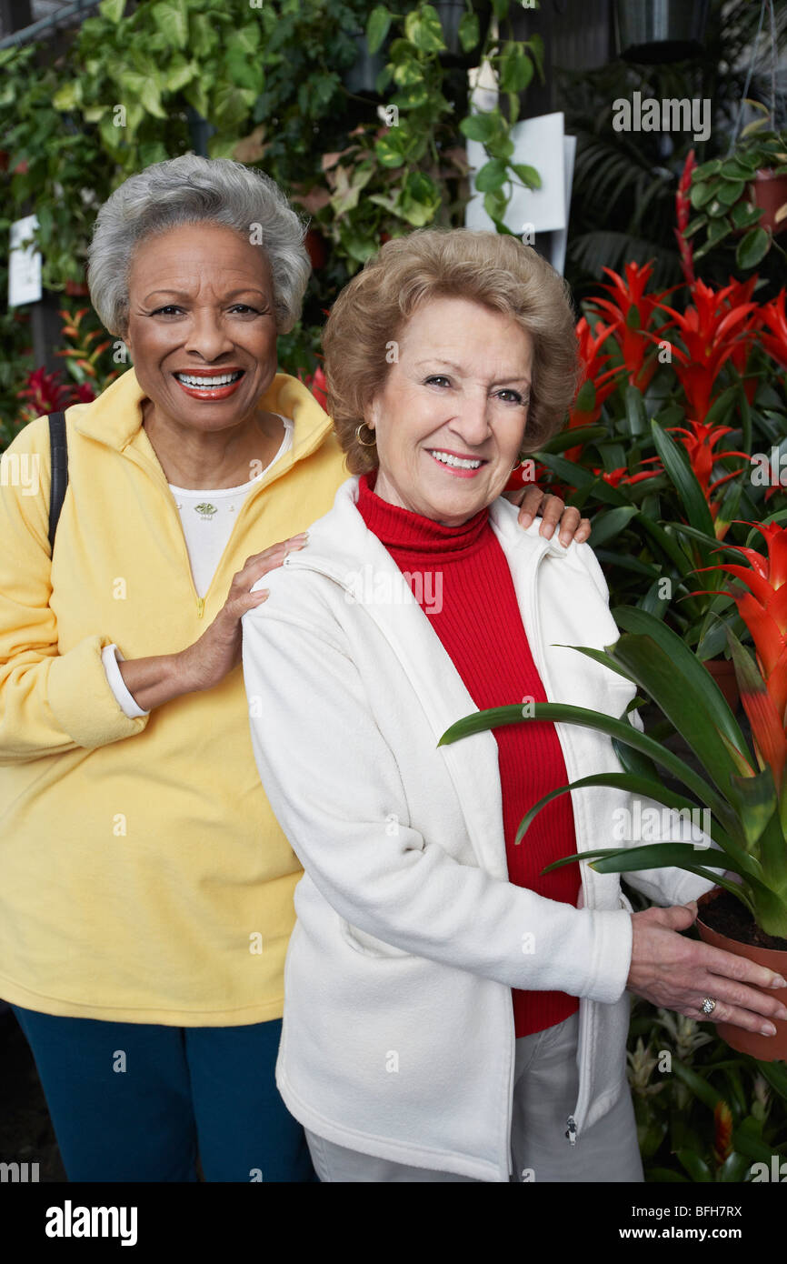Two senior women in garden center Stock Photo - Alamy