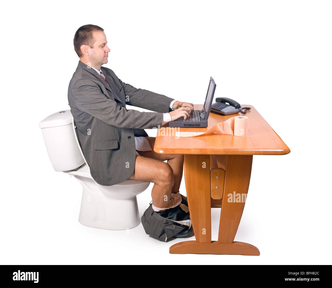 man sitting on the toilet in office Stock Photo Alamy