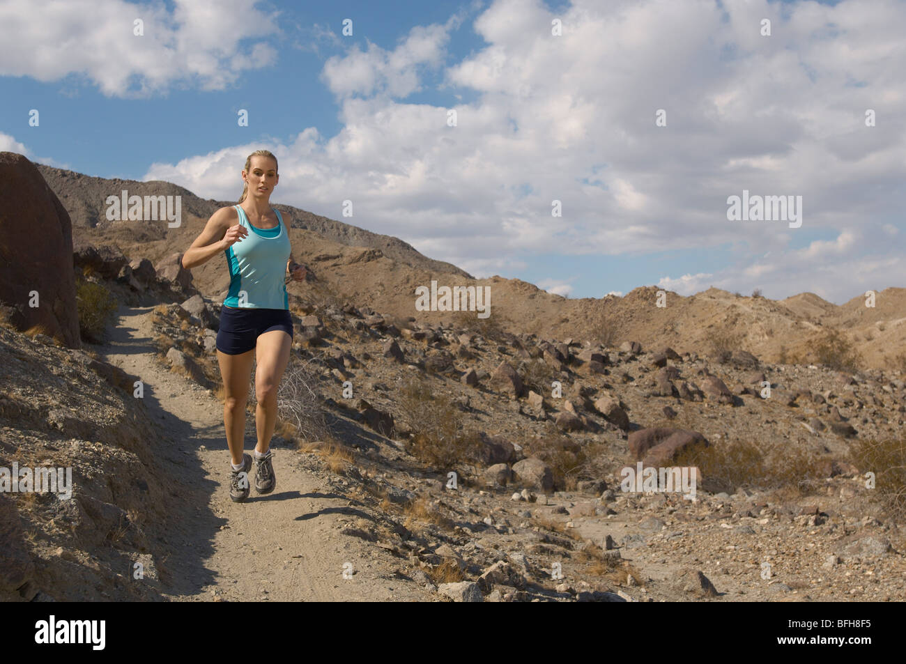 Young woman jogging in mountains Stock Photo - Alamy