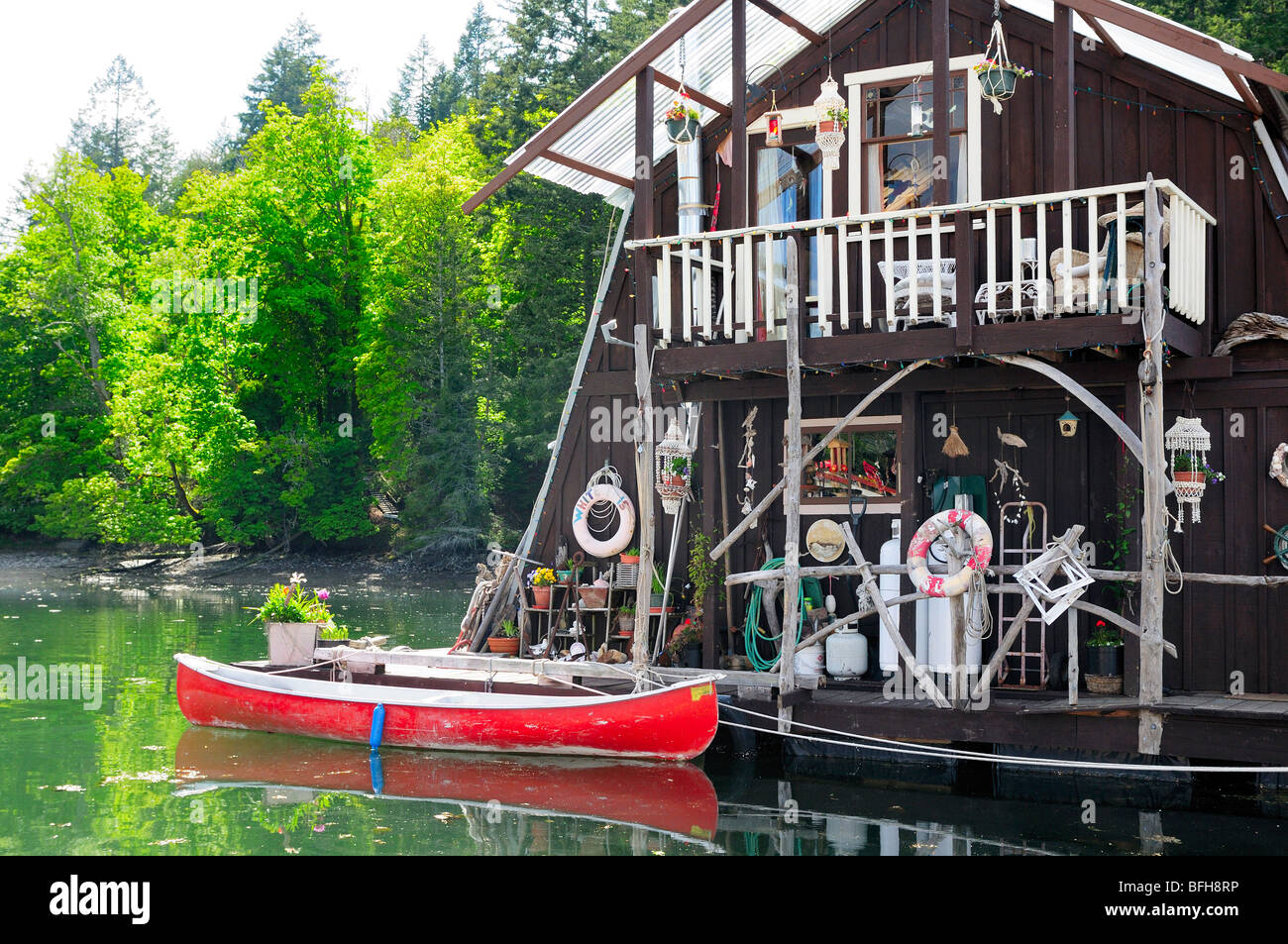 Float home and canoe at marina in Genoa Bay, near Duncan, BC. Stock Photo