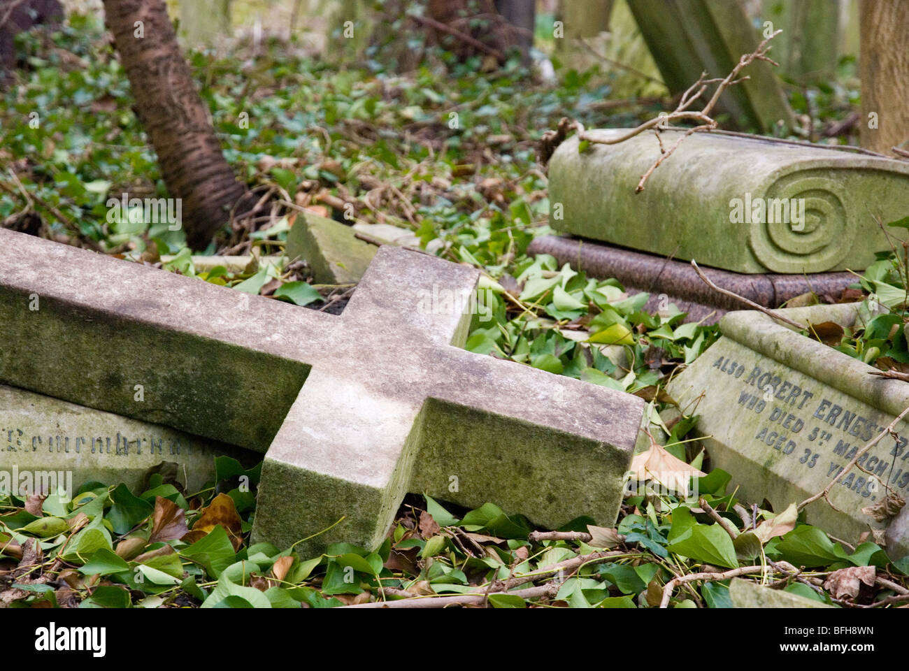 Cross gravestone lying on ground at Highgate cemetery, London England