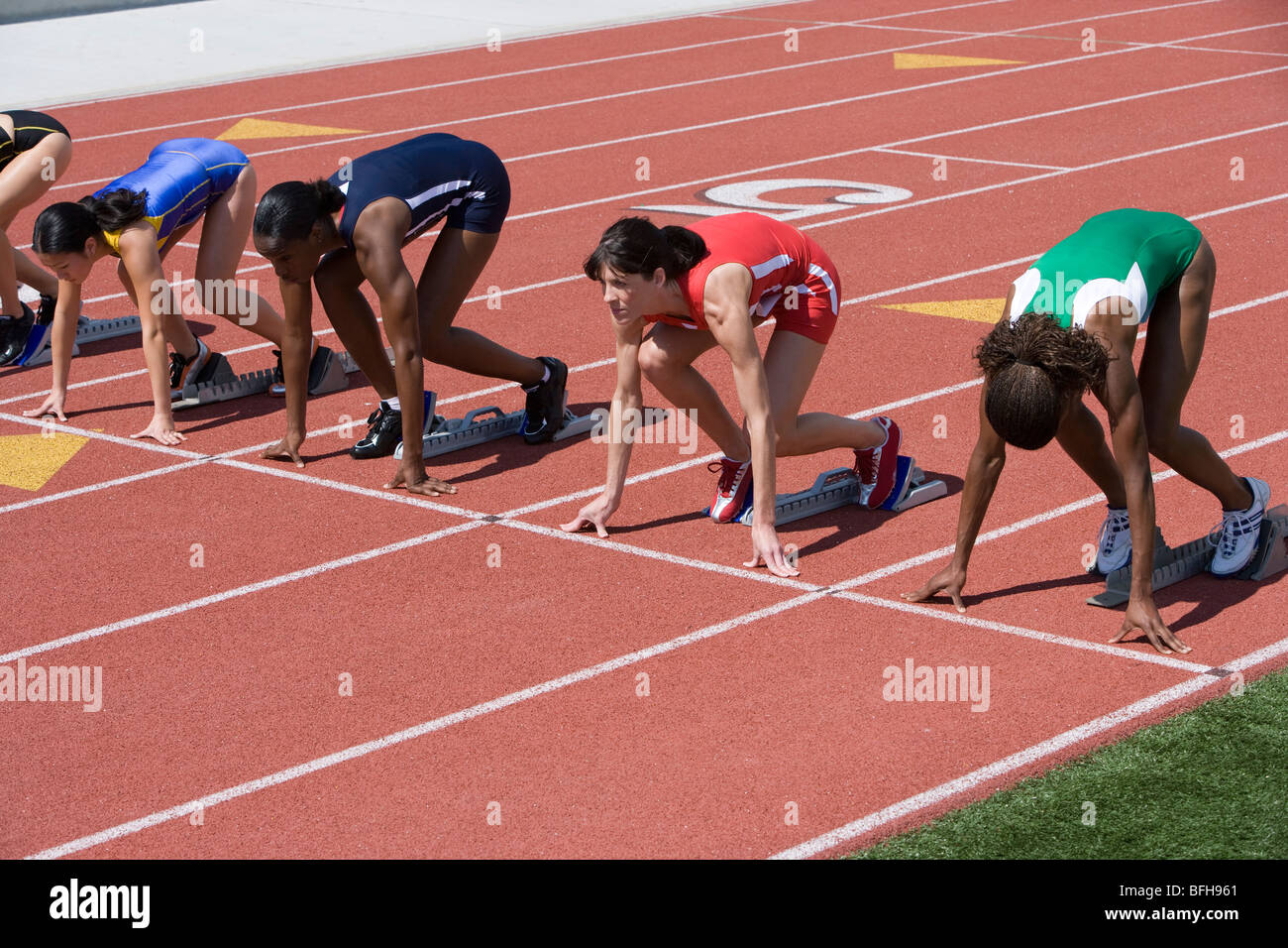 Female athletes in starting blocks hires stock photography and images