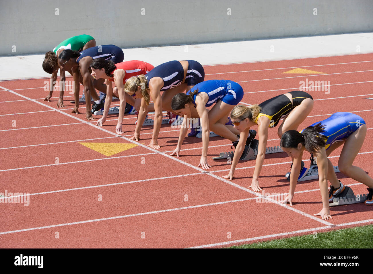 Female athletes in starting blocks hires stock photography and images