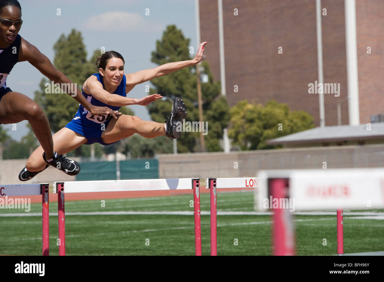 Female athletes hurdling Stock Photo Alamy