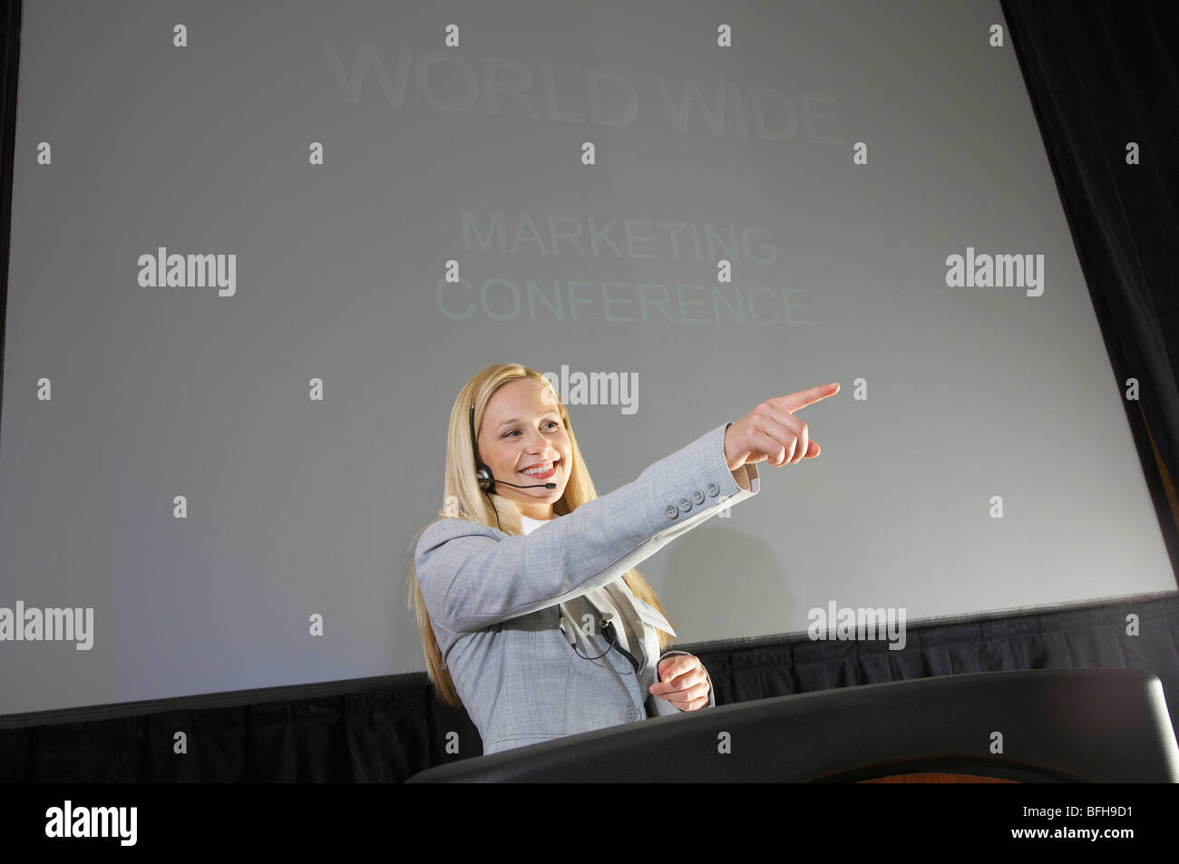 Young woman having presentation at conference Stock Photo