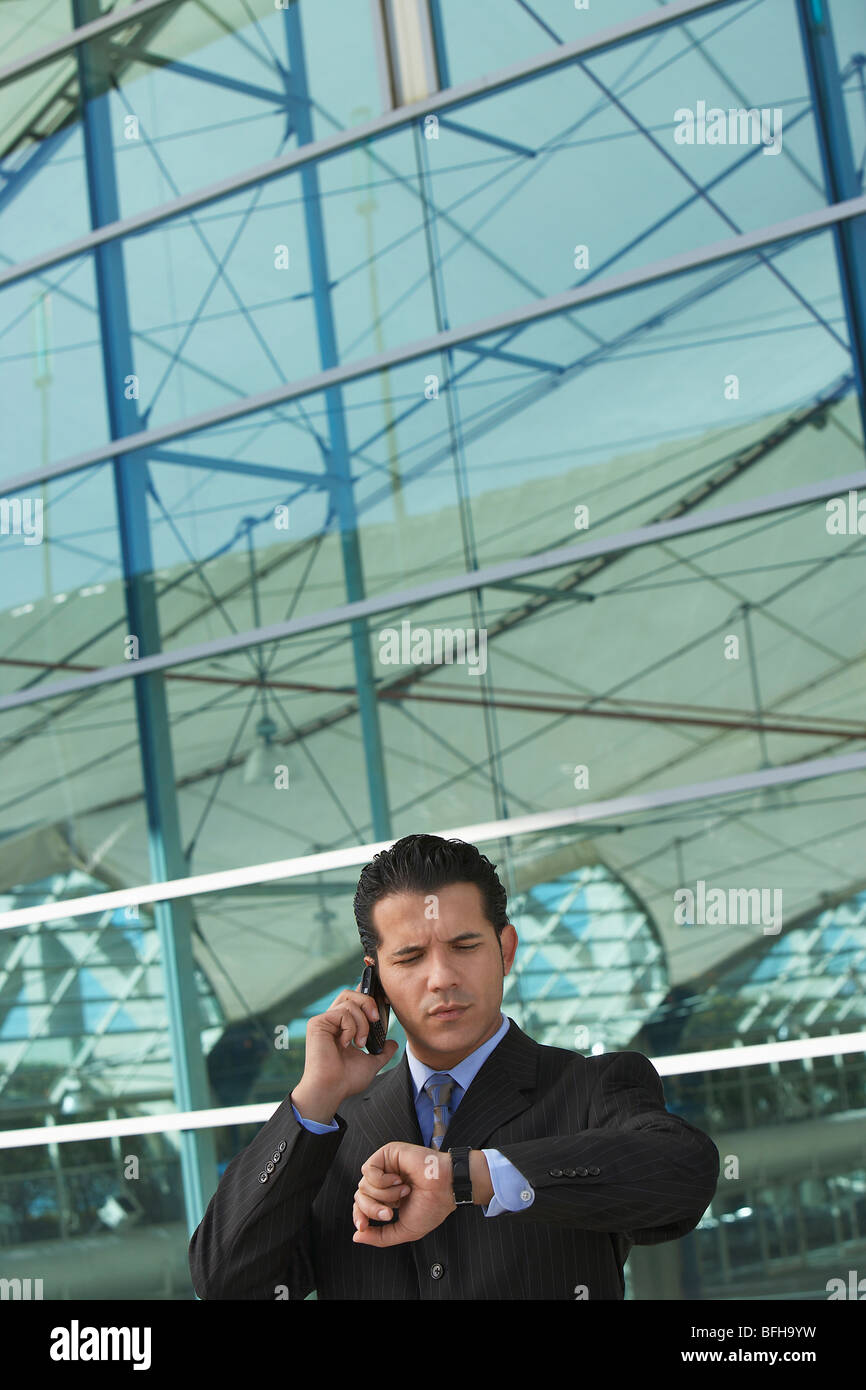Man outside building checking hi-res stock photography and images - Alamy