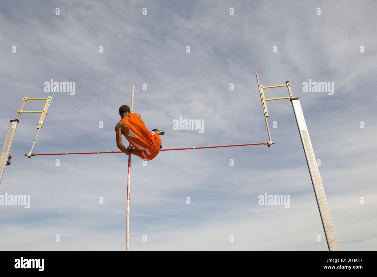 Pole vaulted in midair, low angle view Stock Photo Alamy