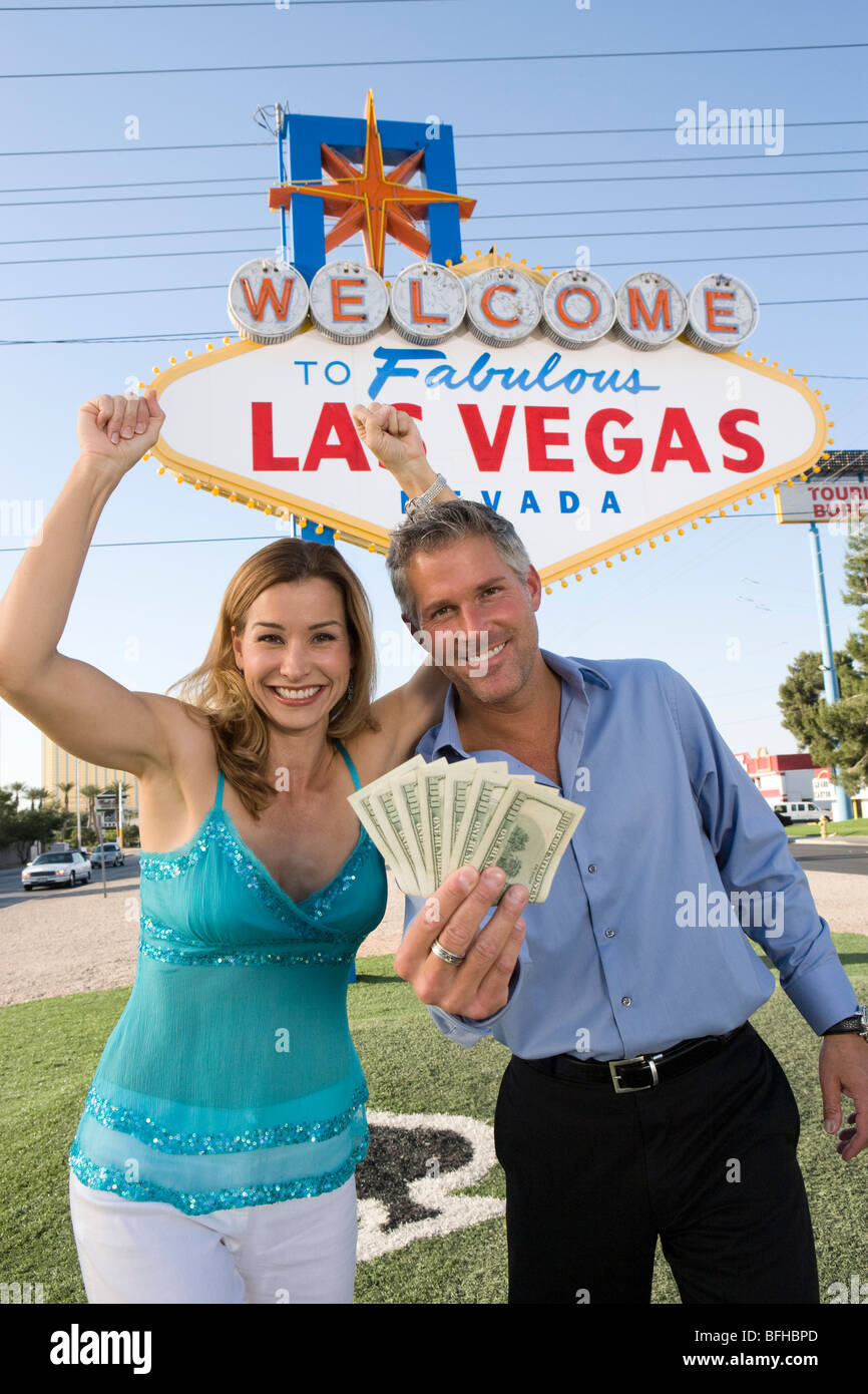 Mid-adult couple in front of Welcome to Las Vegas sign, portrait Stock Photo