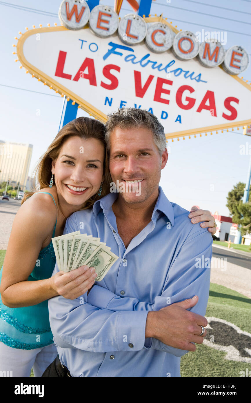 Mid-adult couple in front of Welcome to Las Vegas sign, portrait Stock Photo