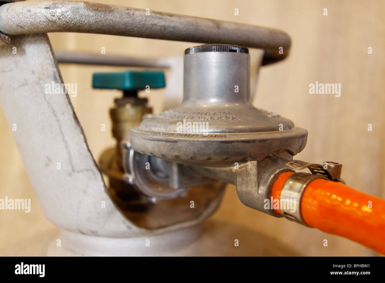 Regulator attached to LPG cylinder with hose and shut-off valve Stock Photo