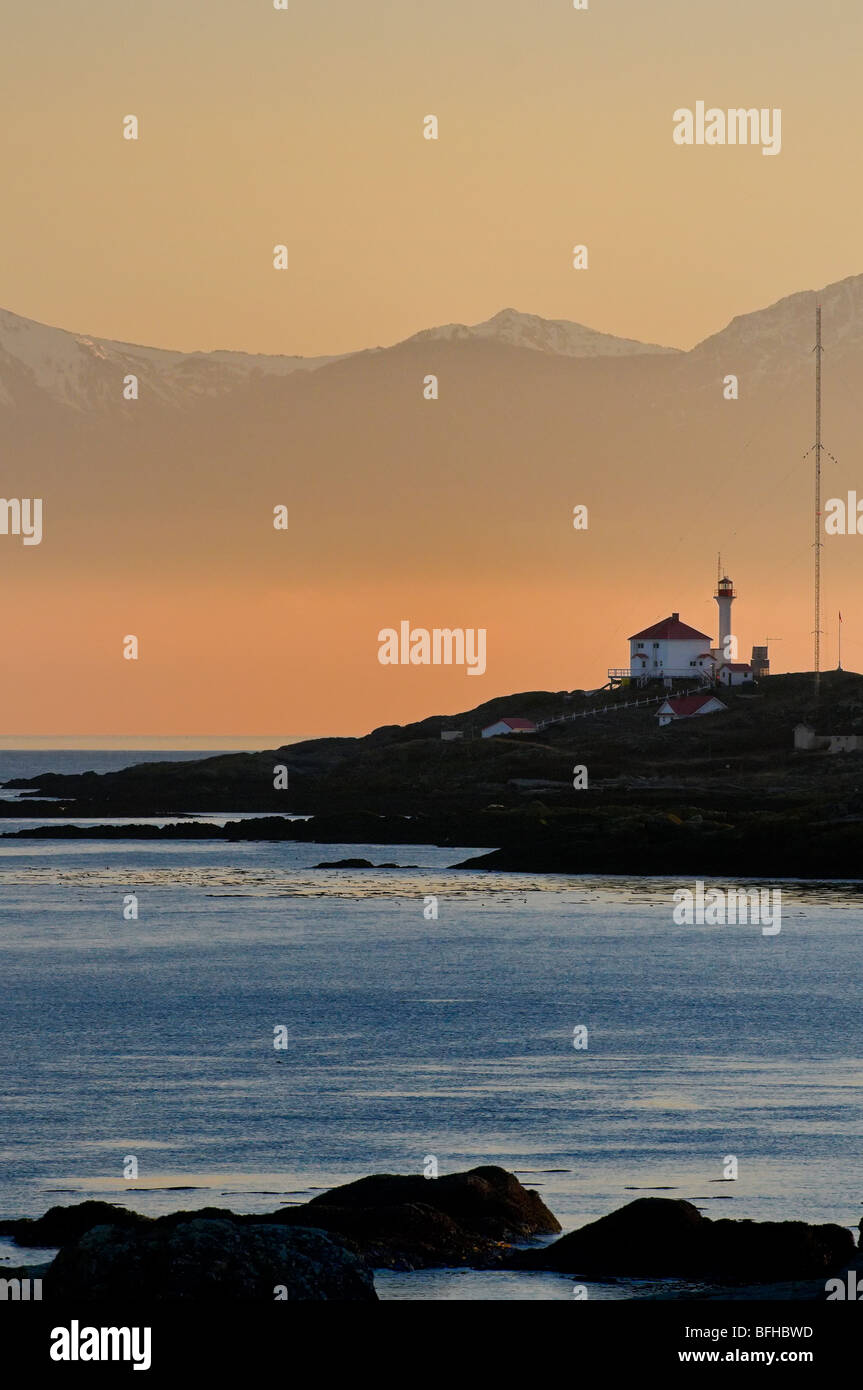 The Olympic Mountains provide a dramatic backdrop for Trial Island Light  near Victoria BC. Stock Photo