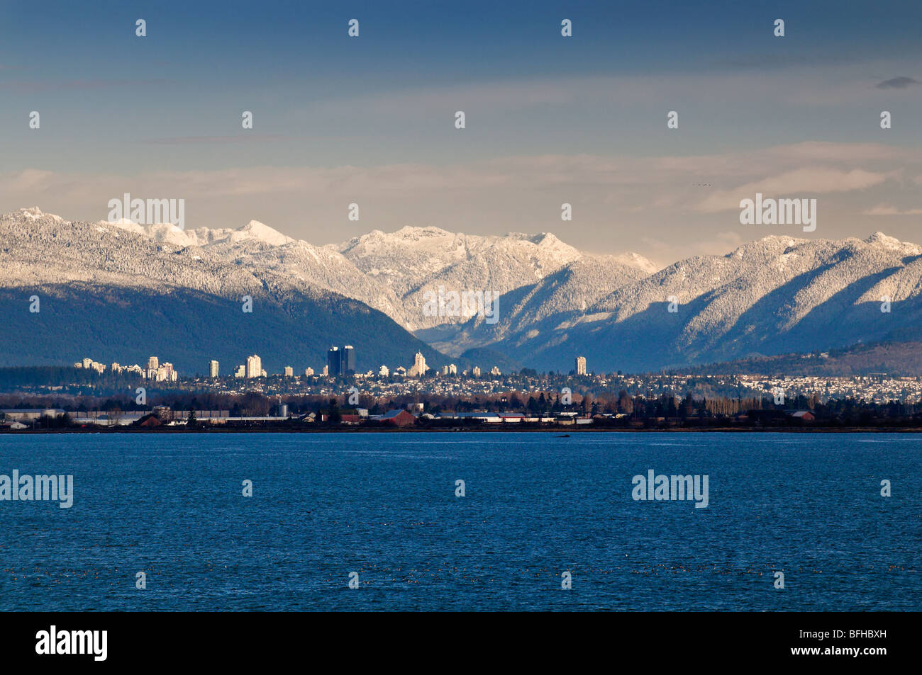Vancouver's skyline with the snow-capped Coast Mountains behind. Stock Photo