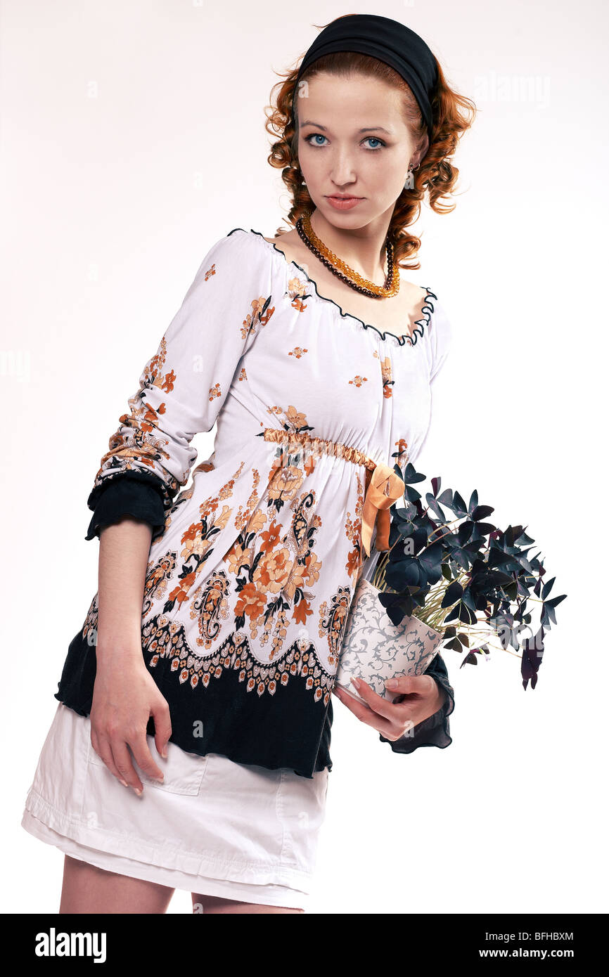 Young woman holding a plant Stock Photo - Alamy