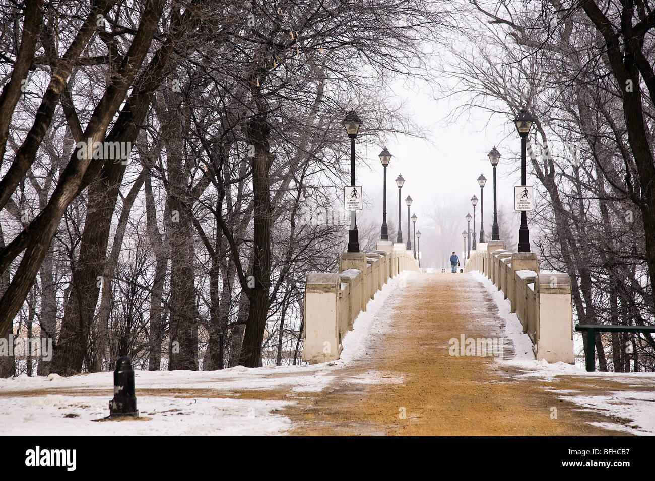 Freshly sanded Assiniboine Park Footbridge on foggy winter morning.  Winnipeg, Manitoba, Canada. Stock Photo