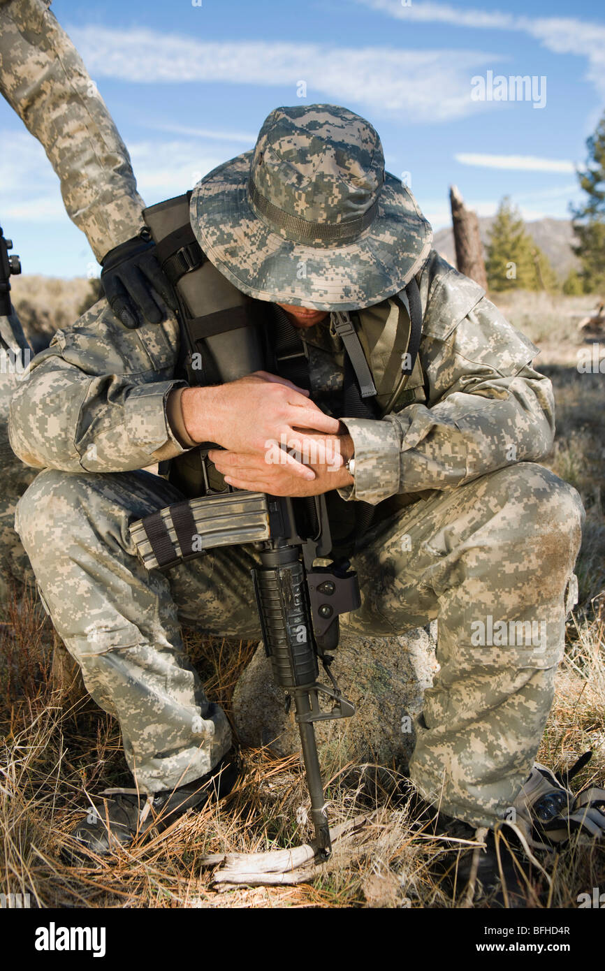 Soldier sitting, looking down Stock Photo Alamy