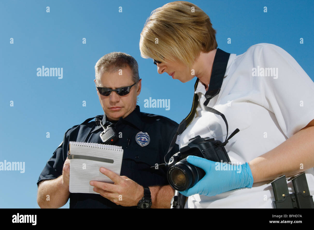 Police Officer and Investigator with Camera Stock Photo