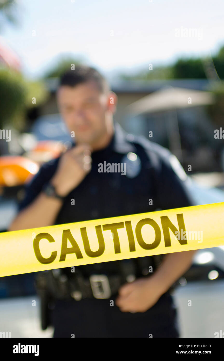 Police Officer Standing Behind Police Tape Stock Photo - Alamy