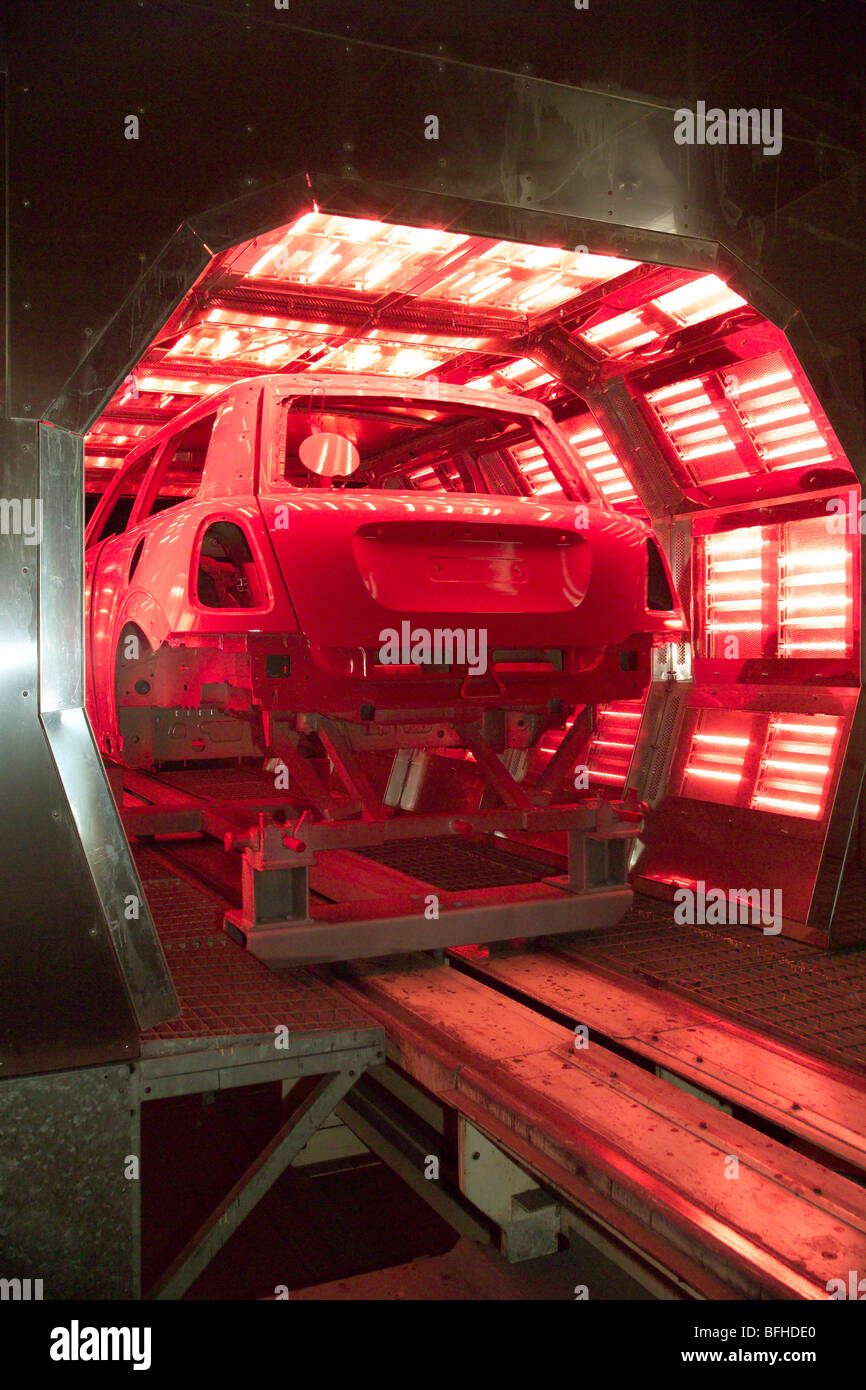 Car body entering a paint drying oven in a car assembly plant Stock