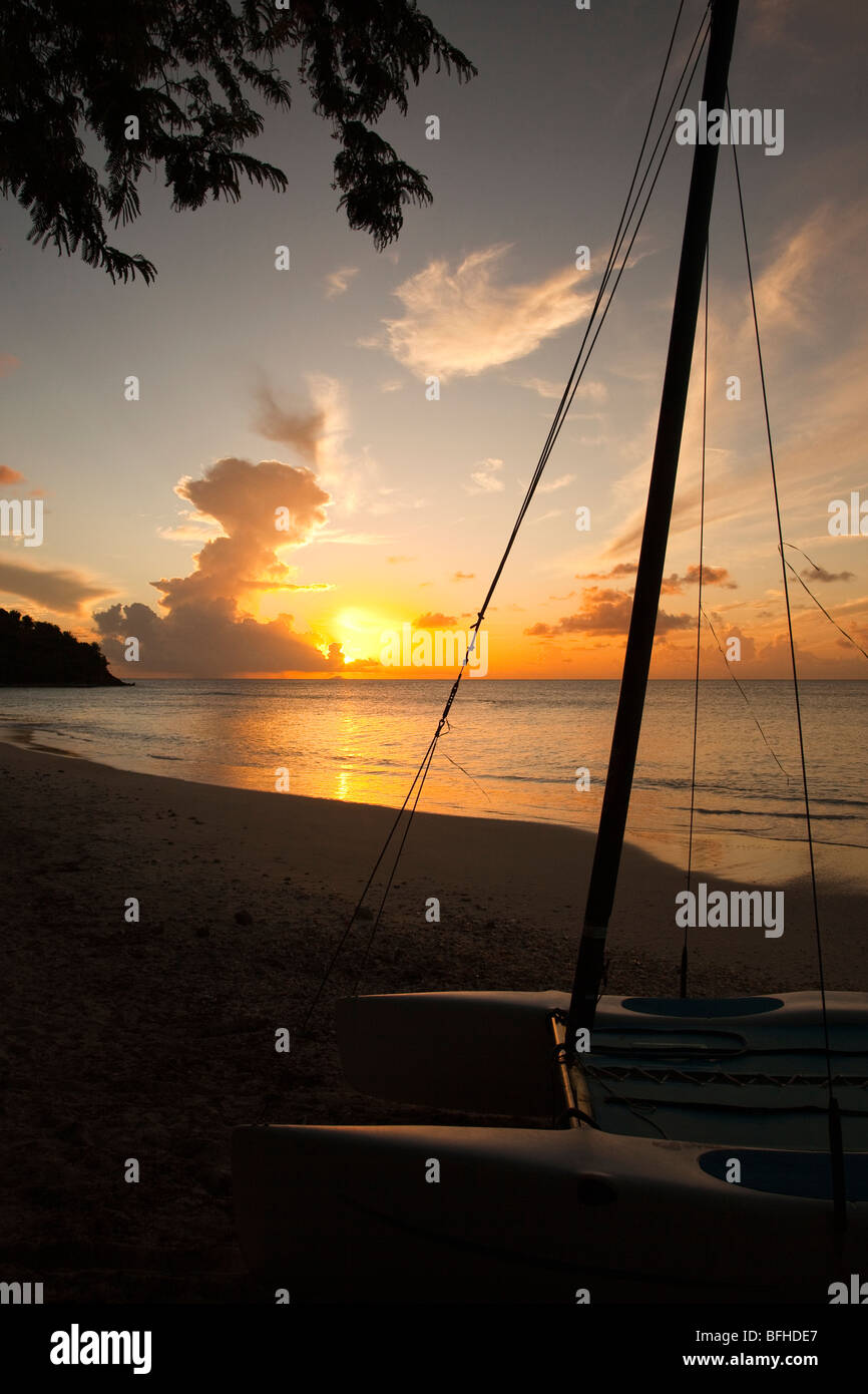 Sunset at Ffryes Bay, Antigua over the hull of a small boat, Caribbean, West Indies Stock Photo