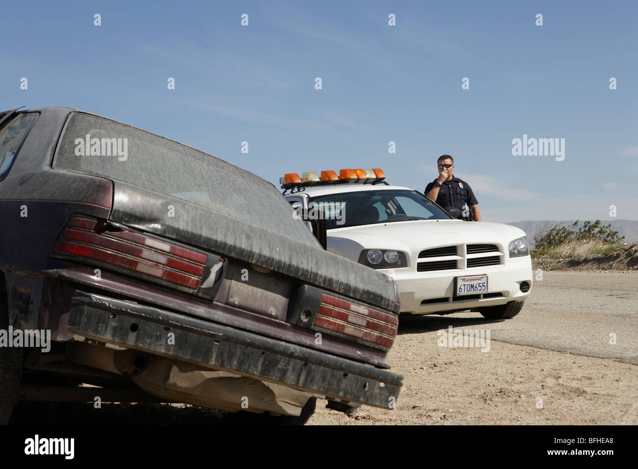 Police officer talking on CB radio on roadside Stock Photo Alamy