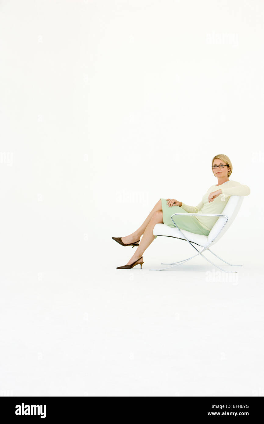 Woman sitting chair full length hi-res stock photography and images - Alamy