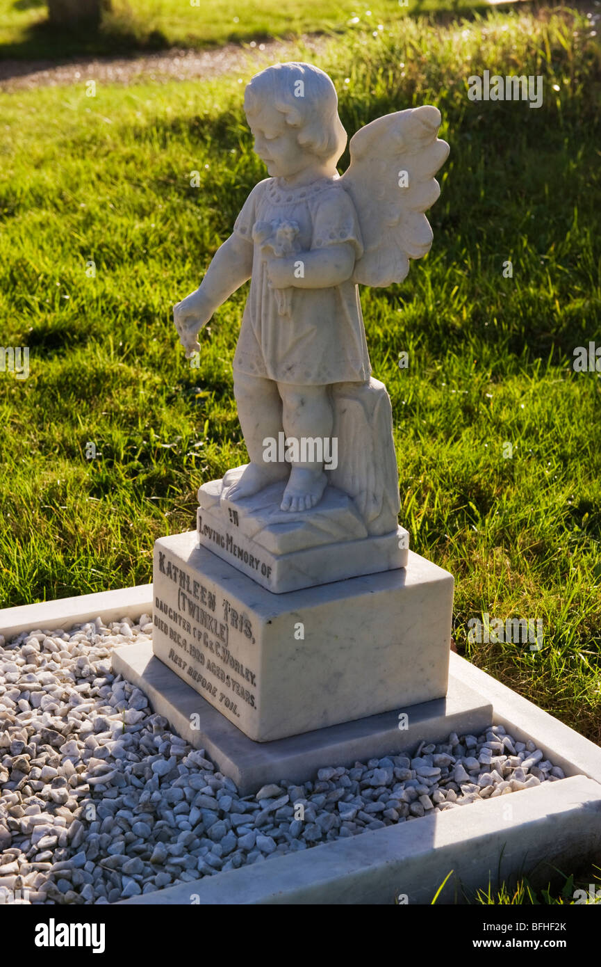 A marble angel memorial stone over a child's grave within the churchyard of Holy Trinity Church, Seer Green, Bucks,UK Stock Photo