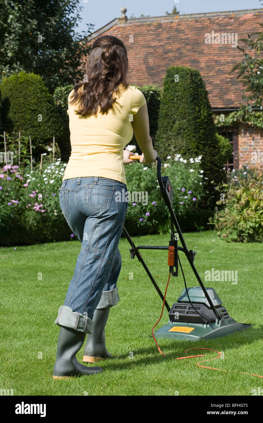 Woman Mowing Lawn Stock Photo