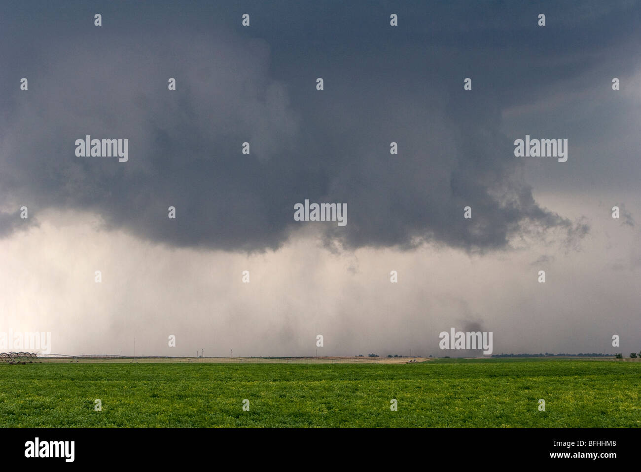 A storm cloud above a green field. June 9, 2009. Stock Photo