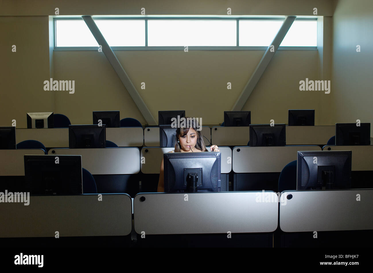 Female student working in computer classroom Stock Photo - Alamy
