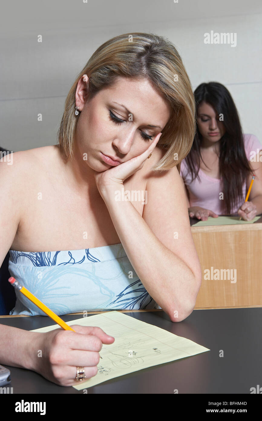 Female student working in class Stock Photo