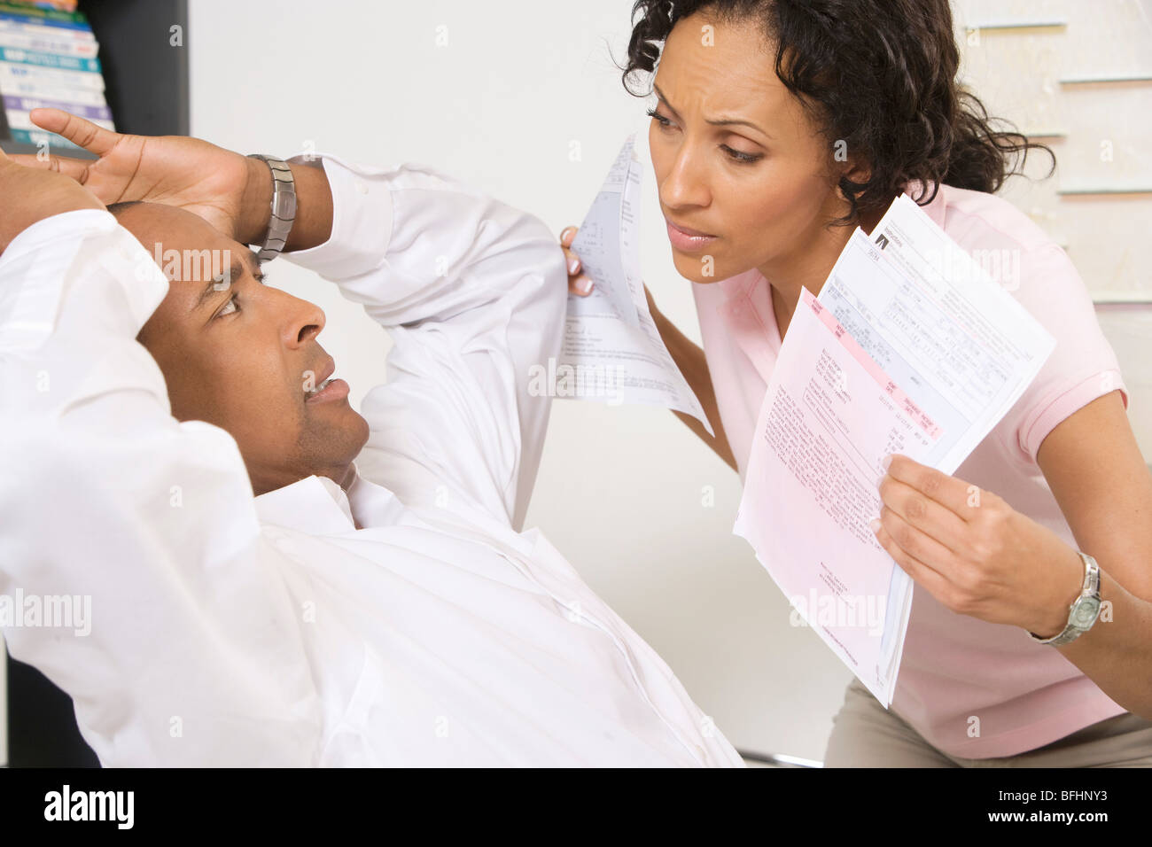 Woman Confronting Man About Bills Stock Photo
