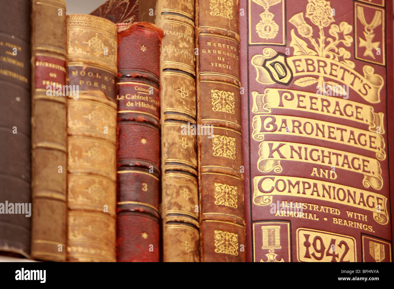 Old books including Debrett's Peerage Baronetage Knightage 1942 on a book shelf Stock Photo