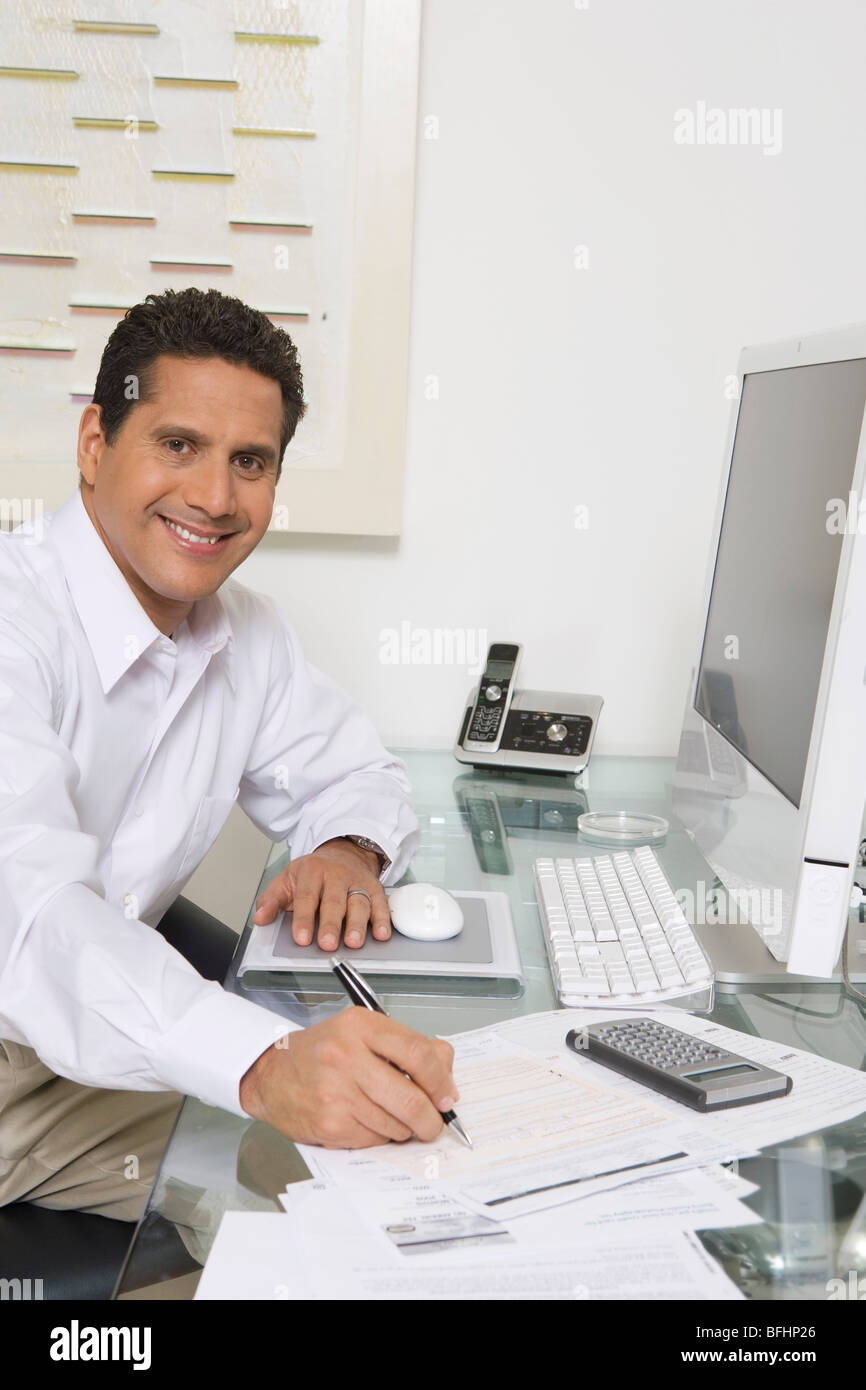 Businessman Working at Desk Stock Photo