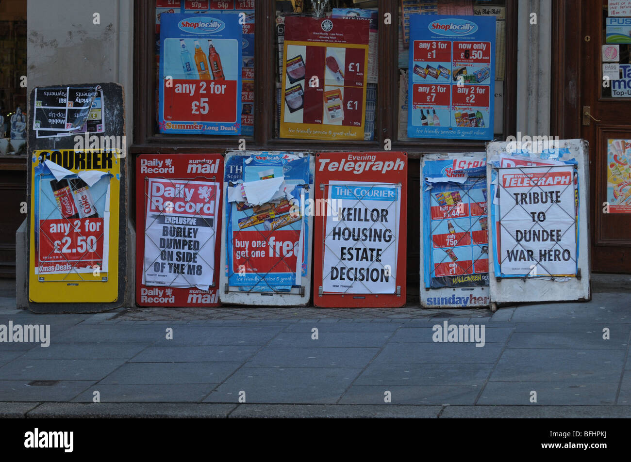 Newspaper headlines on advertising boards outside a newsagent. Stock Photo