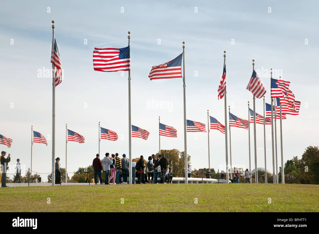 Tourists standing under many American Flags , The monument, Washington DC, USA Stock Photo