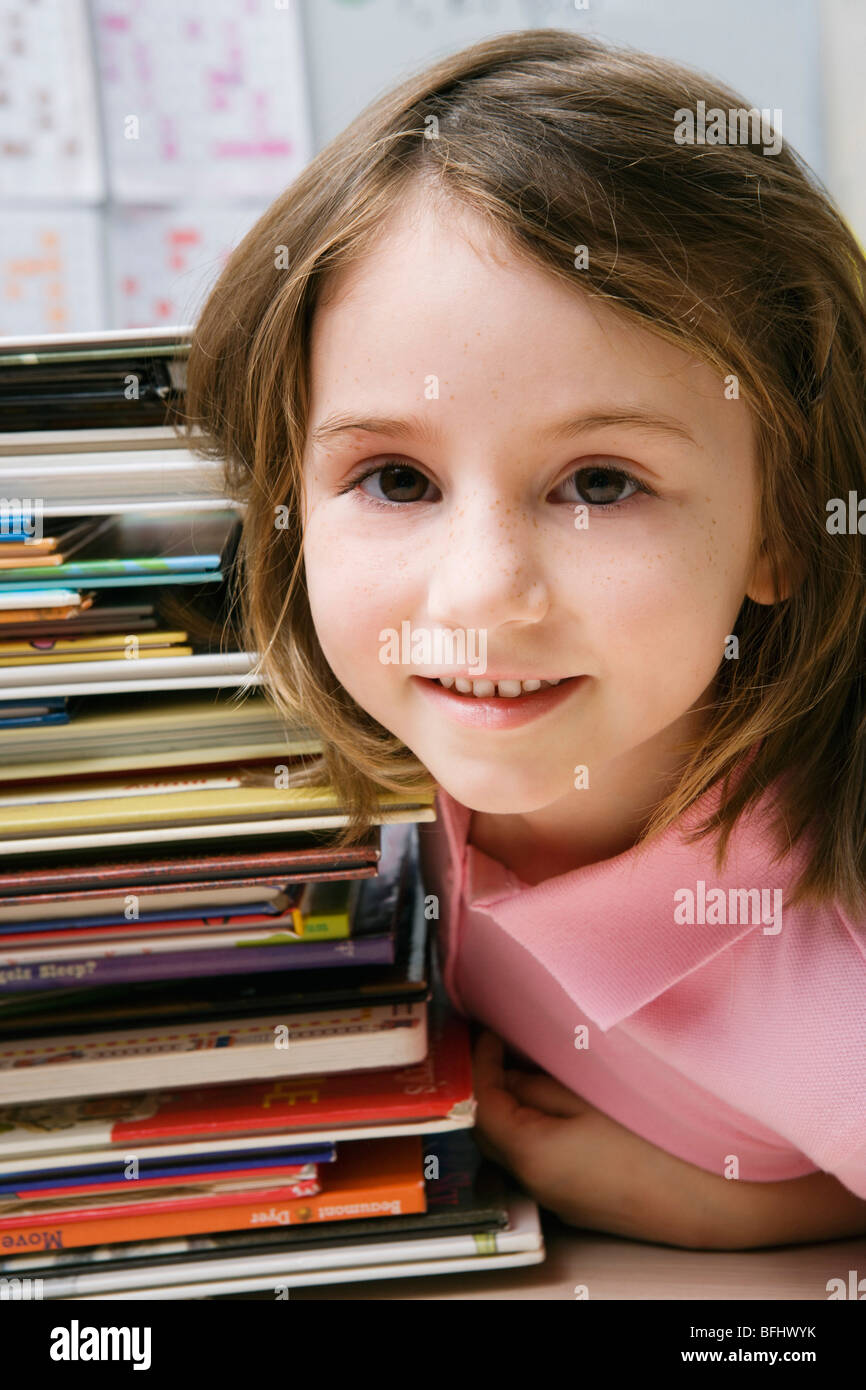 Little Girl with a Stack of Books Stock Photo - Alamy