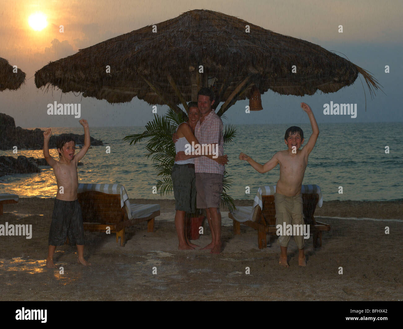 family enjoying their vacation in a resort under the monsoon rain at