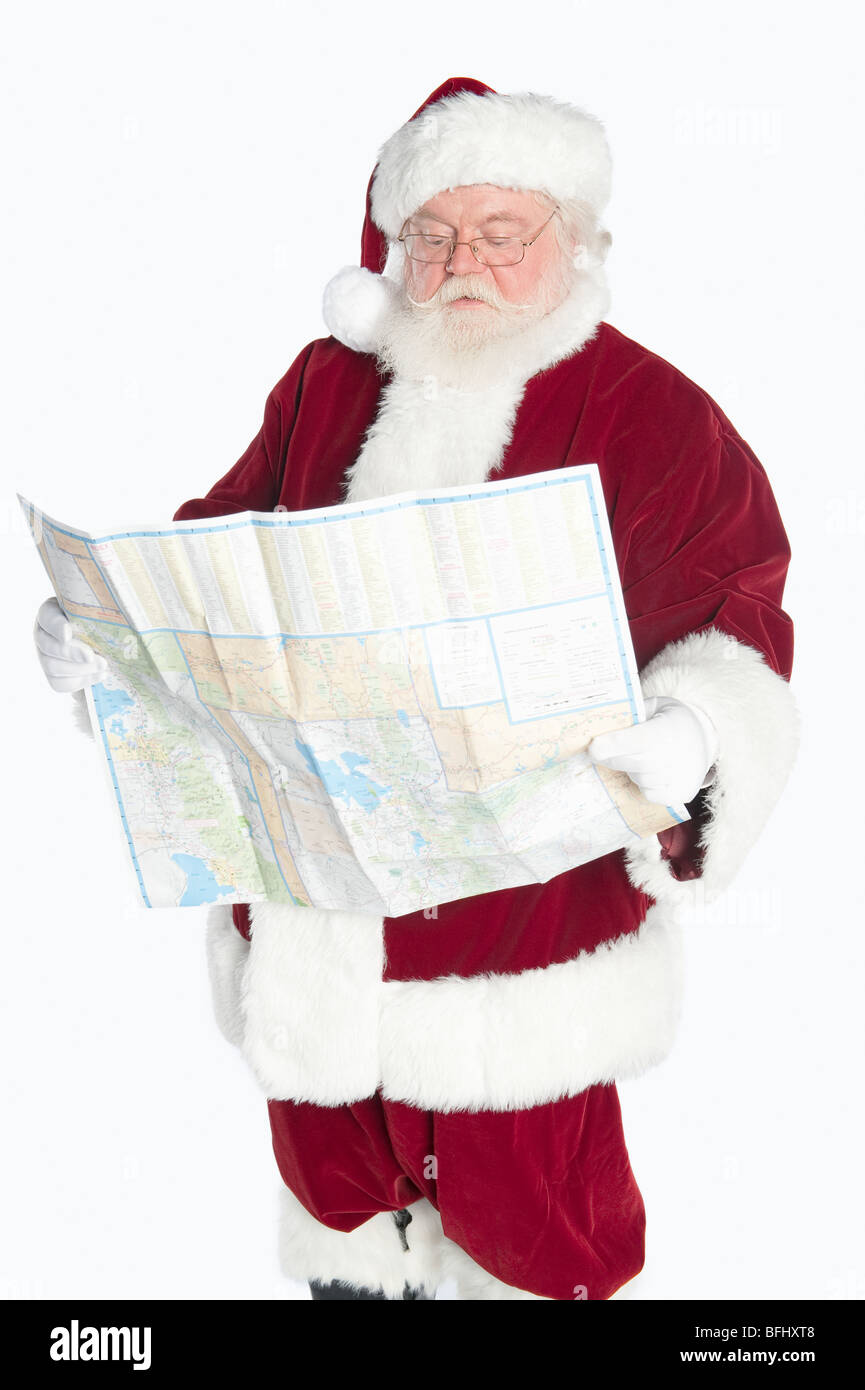Santa Claus holding map Stock Photo Alamy