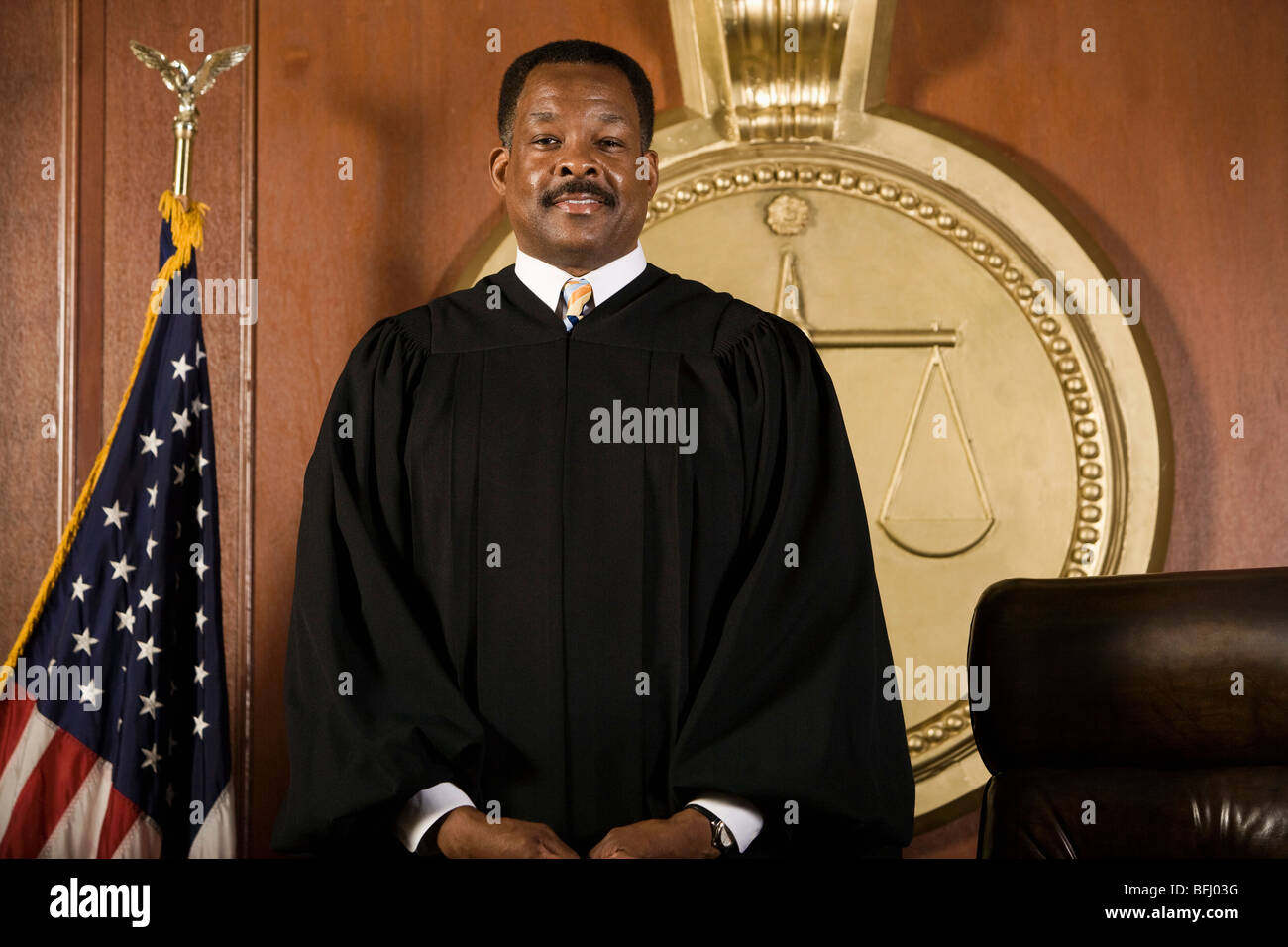 Middleaged judge standing in a courtroom Stock Photo Alamy