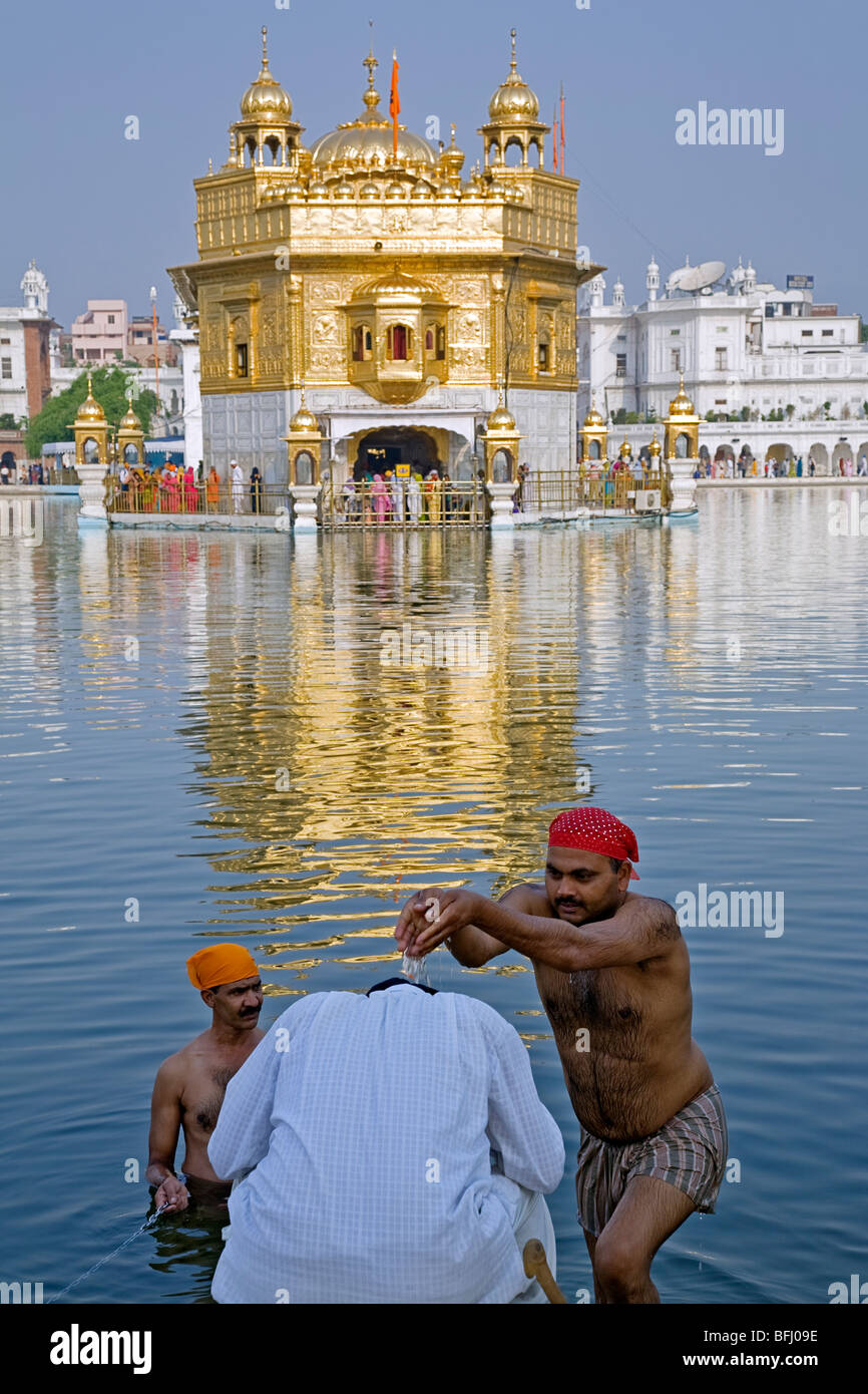 Sikh man blessed with water from the sacred pool (Amrit Sarovar). The Golden Temple. Amritsar. Punjab. India Stock Photo