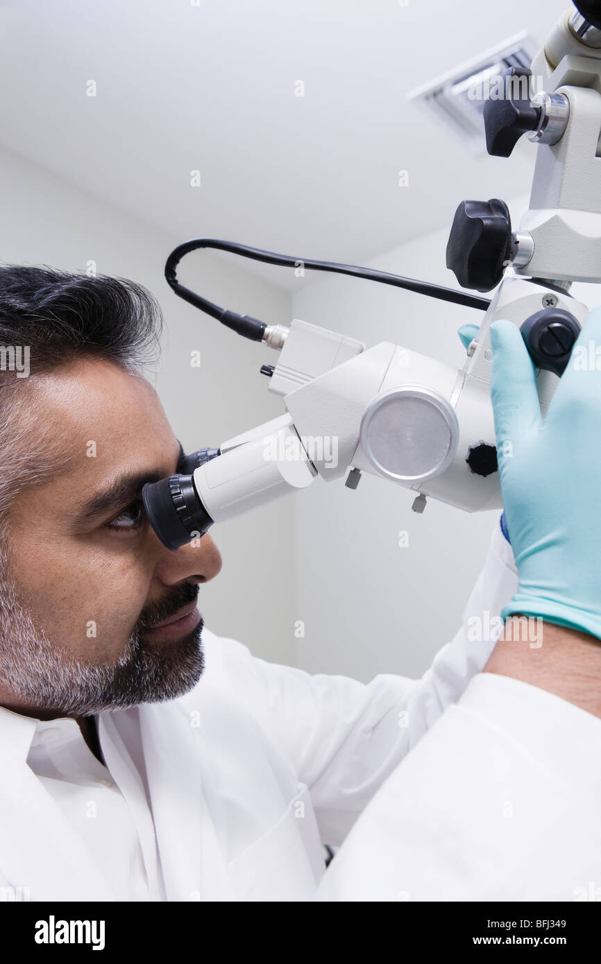Doctor using microscope Stock Photo - Alamy