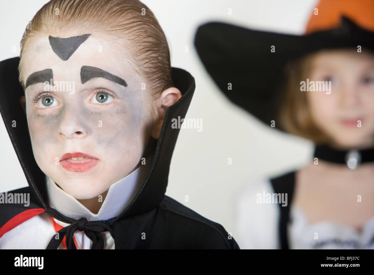 Boy (7-9), wearing dracula costume, girl in background Stock Photo