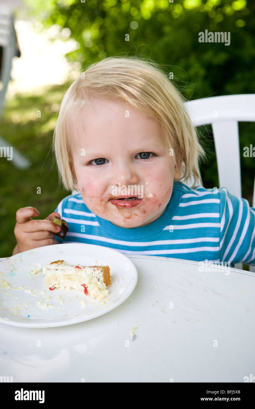 A little boy eating cake, Sweden Stock Photo Alamy
