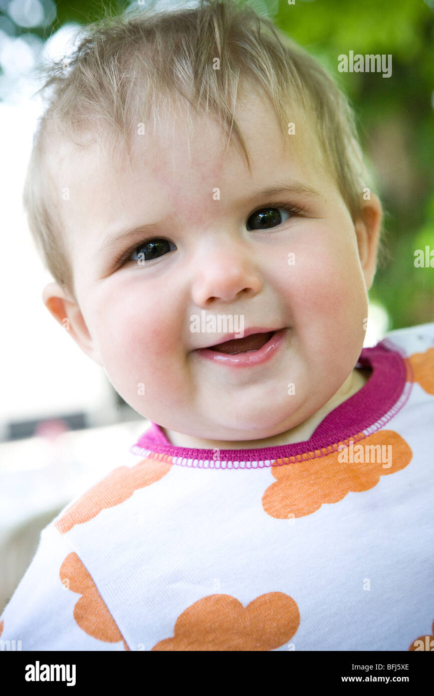 Little girl wearing orange shirt hires stock photography and images