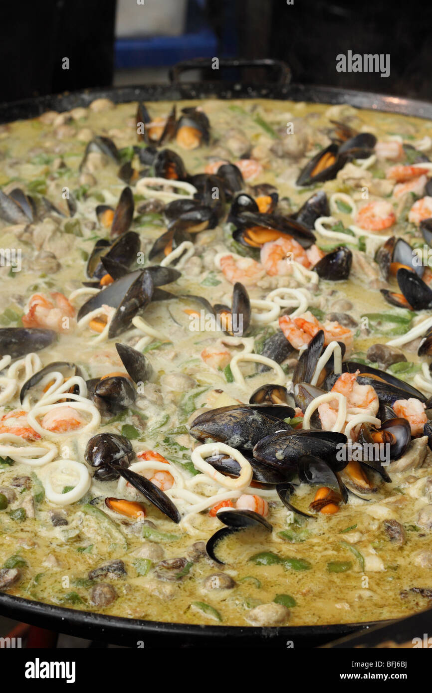 Thai Green curry with seafood squid and mussels at Borough Market Southwark London Stock Photo