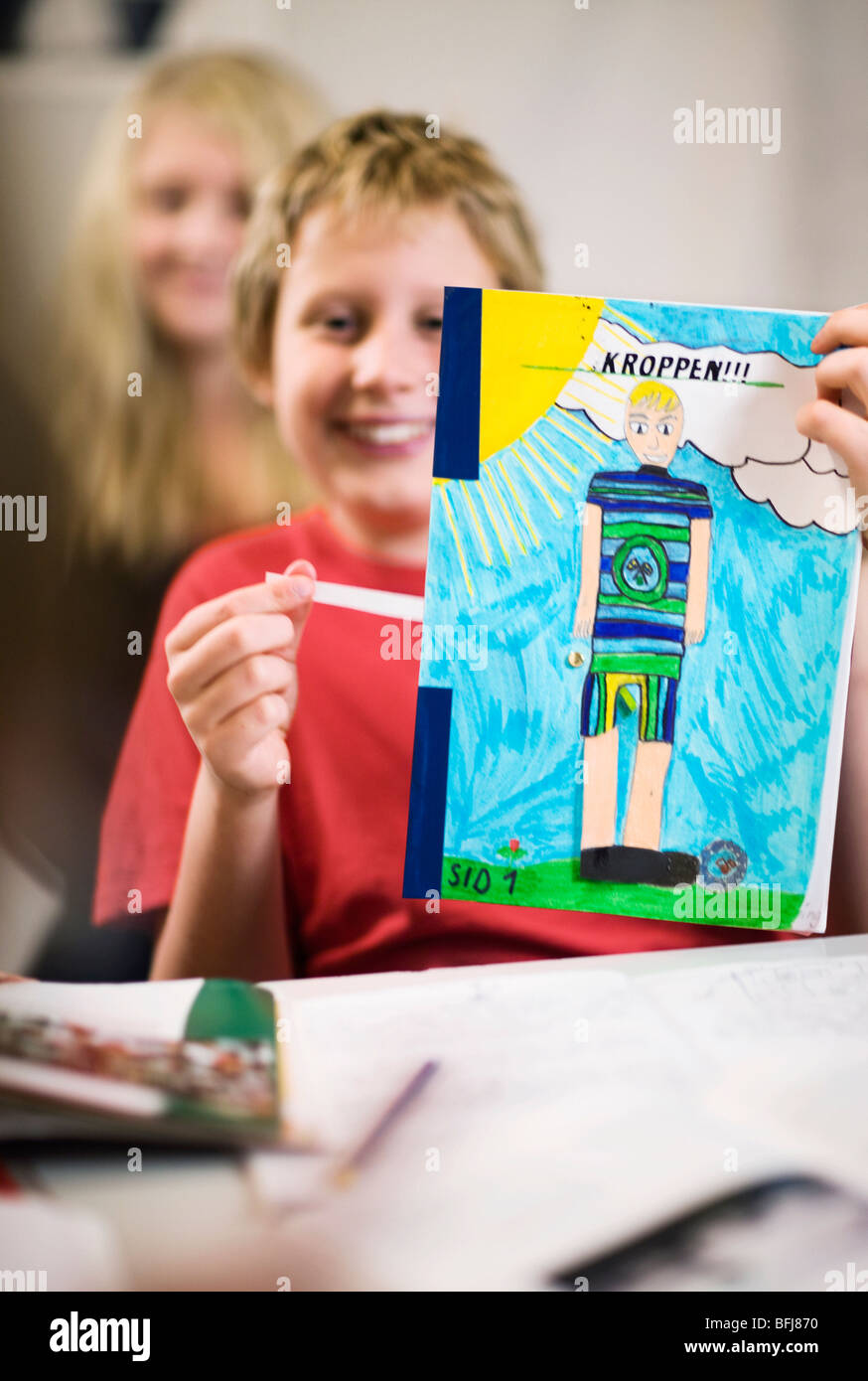 Boy showing a schoolwork, Sweden. Stock Photo