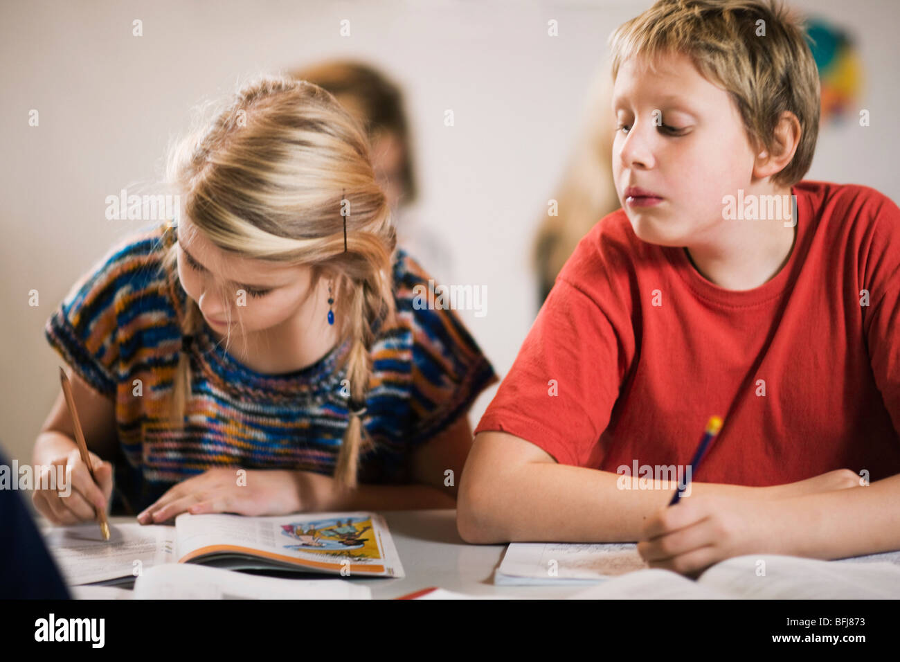Schoolboy having a peep at what his classmate is writing, Sweden. Stock Photo